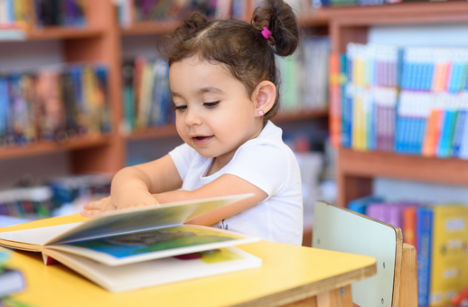 child reading book in library